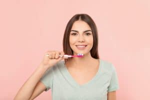 young woman about to brush her teeth